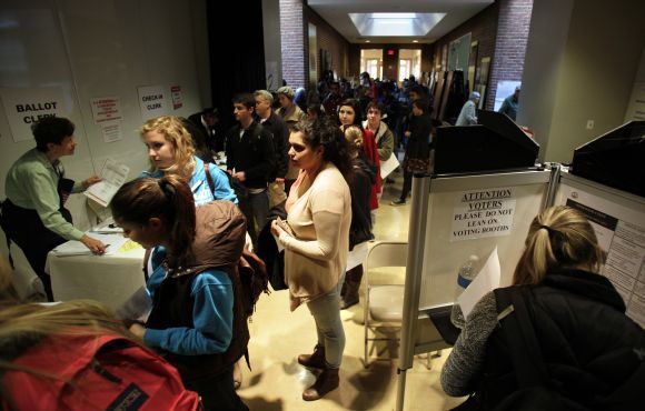 People wait to vote during the US presidential election at the School Without Walls polling station in Washington on Tuesday.