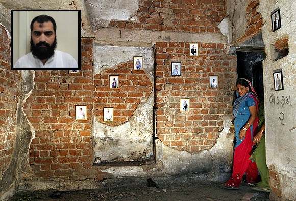 A survivor stands next to pictures of her family members inside her house that was burnt and damaged during the Gujarat riots in 2002. (Inset) Abu Jundal