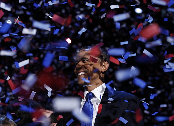 Obama celebrates on stage as confetti falls after his victory speech during his election rally in Chicago