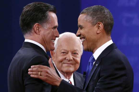 US President Barack Obama and Republican presidential nominee Mitt Romney shake hands at the start of the final presidential debate at Lynn University in Boca Raton, Florida October 22, 2012. At center is moderator Bob Schieffer.