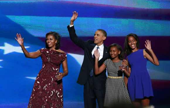 Obama is joined onstage by first lady Michelle Obama and his daughters Sasha and Malia