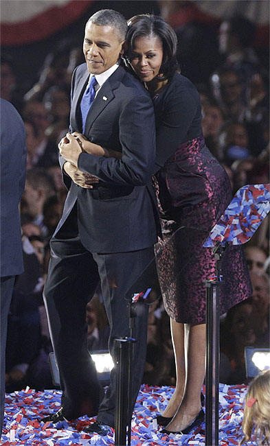 US President Barack Obama is embraced by first lady Michelle Obama after his victory speech during his election night rally in Chicago