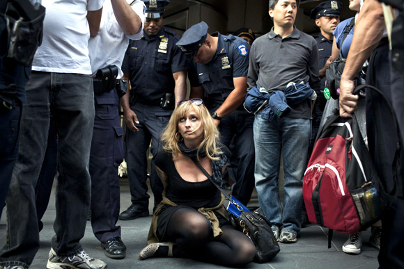 An Occupy Wall Street activist is arrested while protesting in the streets of New York's financial district