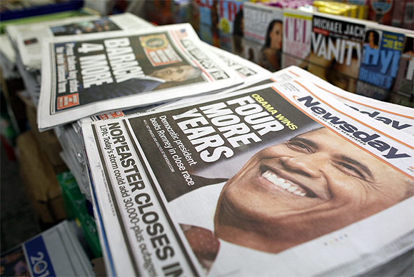 A view shows newspapers with Barack Obama winning the US presidential election on their frontpages, at a news stand in Times Square.