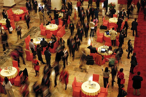 Delegates walk through a hall inside the Great Hall of the People