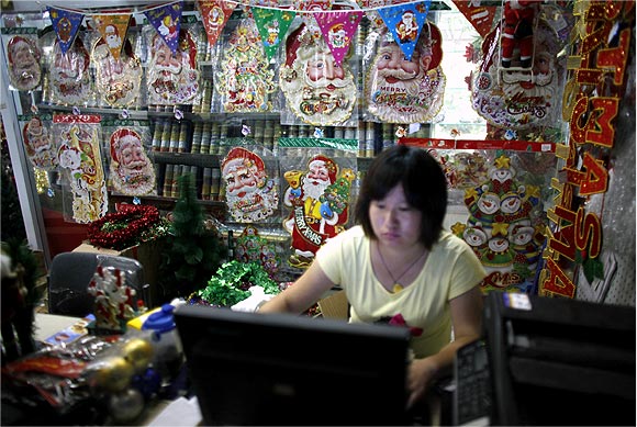 A woman works on a computer at a Christmas decoration shop in Yiwu, Zhejiang province