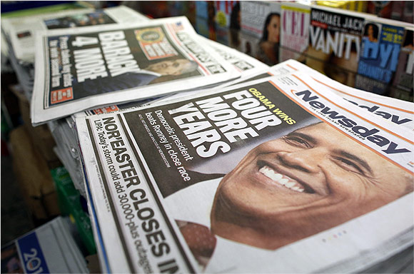 A view shows newspapers with Barack Obama winning the US presidential election on their frontpages, at a news stand in Times Square, New York
