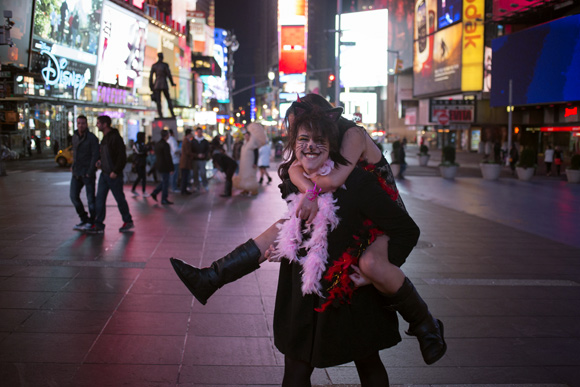 Revellers dressed up for Halloween play around in Times Square, New York