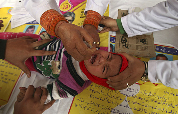 A child receives polio drops during a polio eradication programme in Jammu
