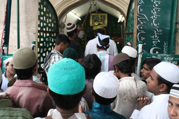 Members of the Muslim community pray at a shrine near Charminar