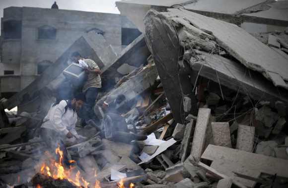 Palestinians inspect the destroyed office building of Hamas Prime Minister Ismail Haniyeh in Gaza City