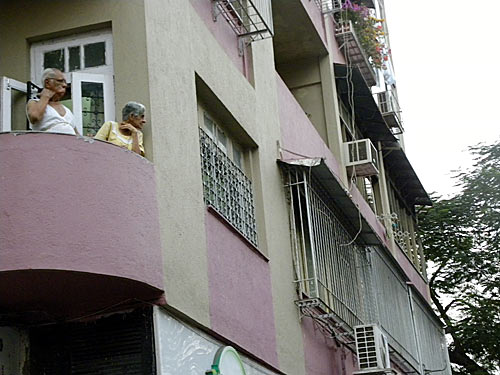 Residents of Colaba in south Mumbai watch as shops shut in the area