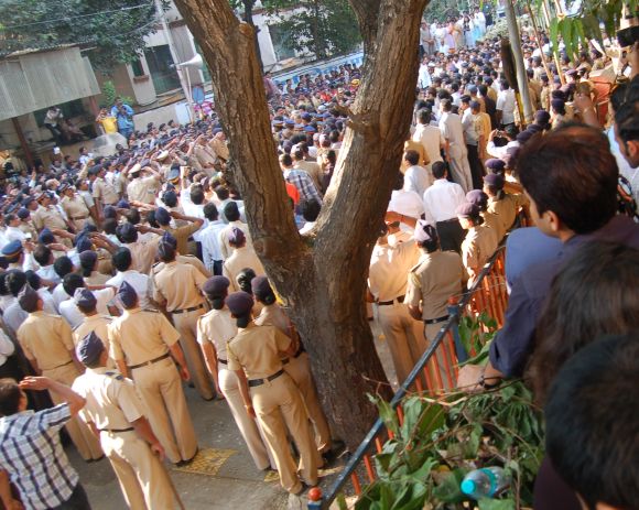 Cops saluting Bal Thackeray's body during the state funeral.