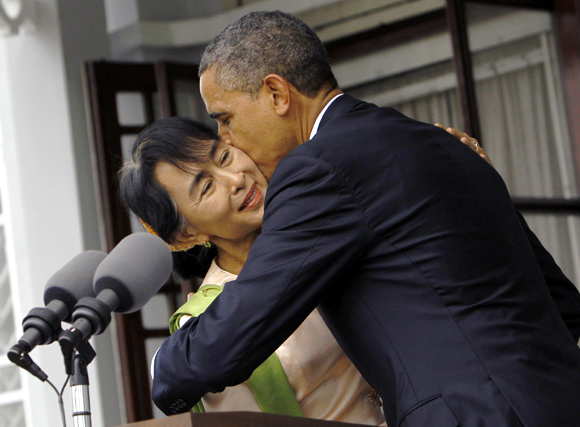 US President Barack Obama kisses Myanmar's opposition leader Aung San Suu Kyi after their meeting at her residence in Yangon