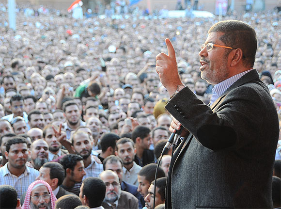 Egypt's President Mohamed Mursi speaks to supporters in front of the presidential palace