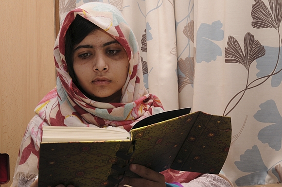 Pakistani schoolgirl Malala Yousufzai reads a book as she recuperates at the The Queen Elizabeth Hospital in Birmingham in this undated handout photograph