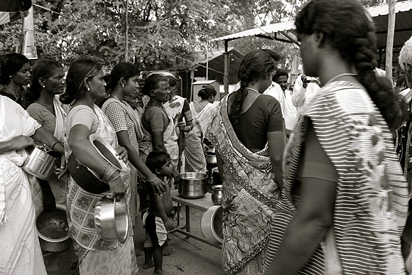 Two weeks after the atrocity, women queue up for lunch at the relief camp in Natham Colony, Dharmapuri