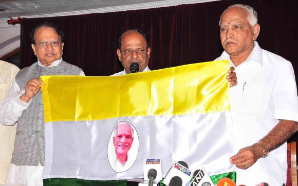 Yeddyurappa unveils the flag of his Karnataka Janata Party in Bangalore on Friday