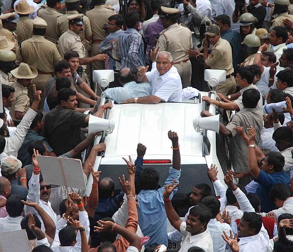 Yeddyurappa waves to cheering supporters in Bangalore on Friday