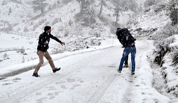 Youths playing with snowballs  near the Baba Reshi shrine