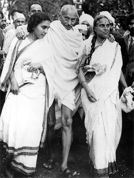 Indian nationalist leader Mahatma Gandhi (Mohandas Karamchand Gandhi) leaving Maor Ville, his Simla residence, during the Leaders Conference.  He is helped to his car by his doctor Sushelia Nayyer, right, and Susila Ben, left, and accompanied by his private secretary Mr Piare Lal.