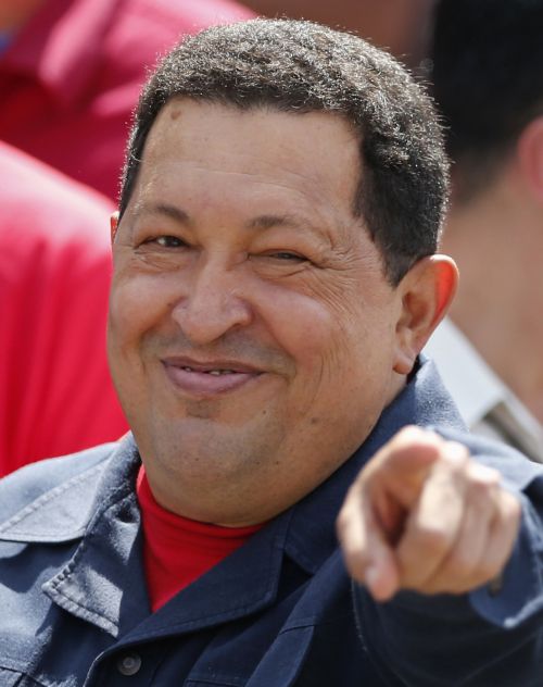 Hugo Chavez gestures to supporters after casting his vote during the presidential elections in Caracas on Sunday