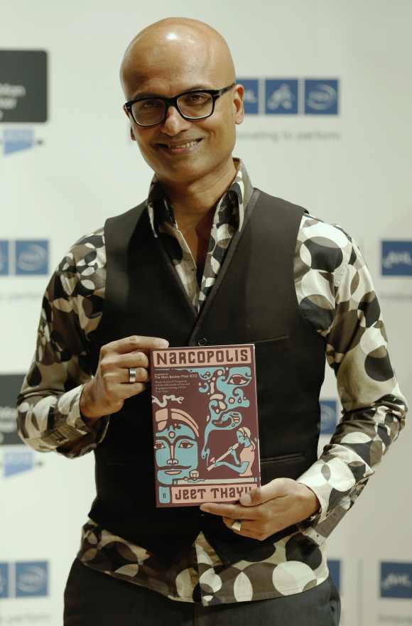 Jeet Thayil of India, one of the shortlisted authors for the 2012 Man Booker Prize, poses with his book 'Narcopolis', in London
