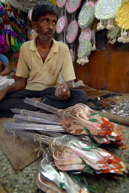 A man selling weapons that the Goddess carries.