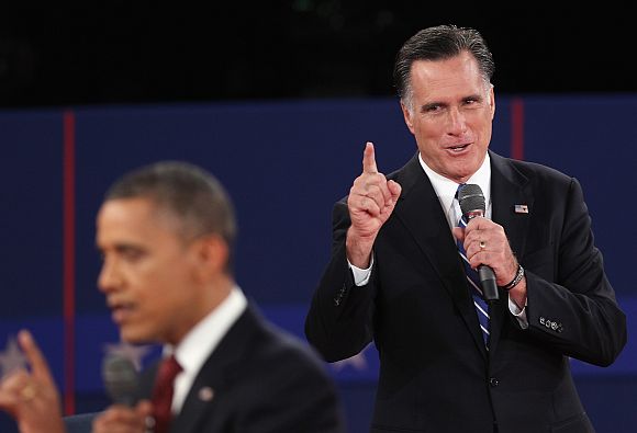 Republican presidential candidate Mitt Romney speaks as US President Barack Obama answers a question