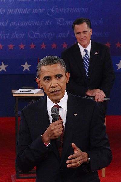 Republican presidential candidate Mitt Romney listens as US President Barack Obama answers a question