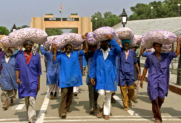 Indian porters carry garlic bags at the India-Pakistan joint check post at Wagah.