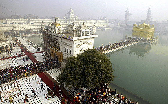 Devotees throng the fog-covered Golden Temple in Amritsar.