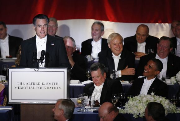 Obama listens to Romney speak at the Alfred E. Smith Memorial Foundation dinner in New York
