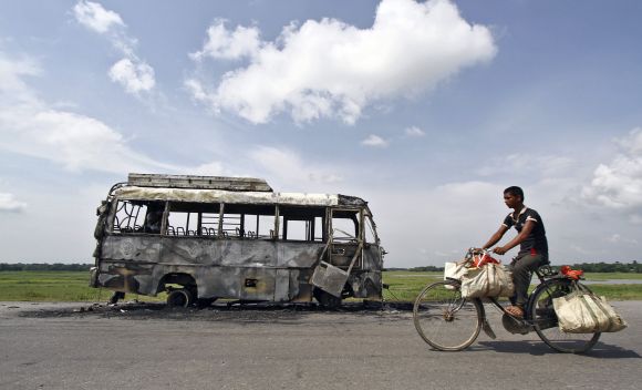 A bus that was burnt by a mob on the national highway near Rongia town during the Assam violence.