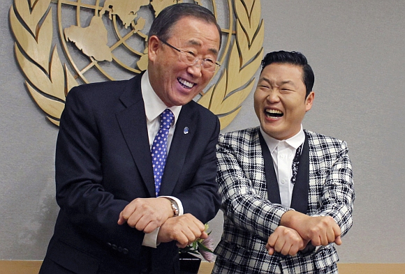South Korean singer Psy and United Nations Secretary-General Ban Ki-moon smile after practicing some 'Gangnam Style' dance steps during a photo opportunity at the UN headquarters in New York