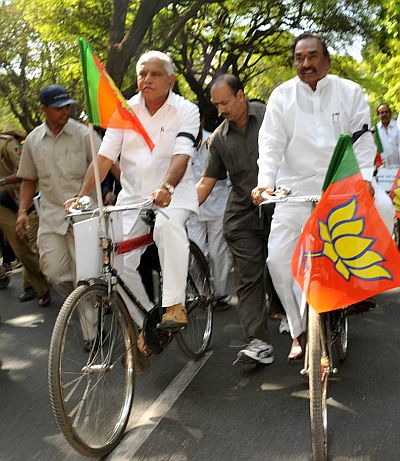 Yeddyurappa with Eshwarappa on a cycle rally