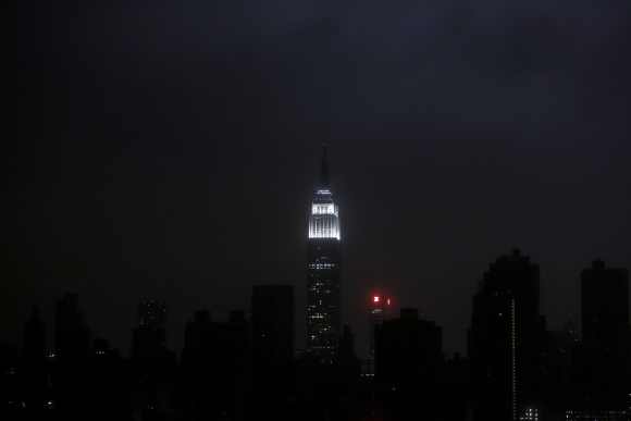 A blacked out New York City skyline is seen from Brooklyn, New York