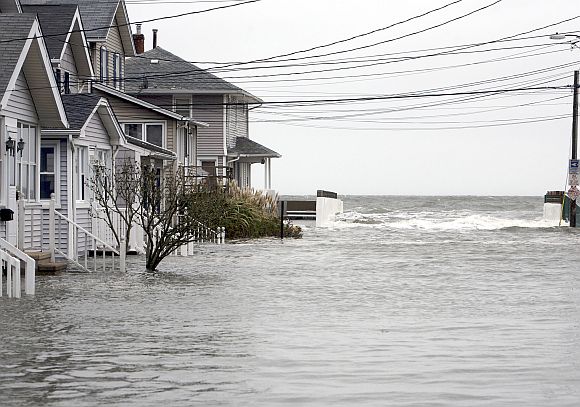 High tide begins to flood a street on the shoreline area of Milford, Connecticut as Hurricane Sandy approaches