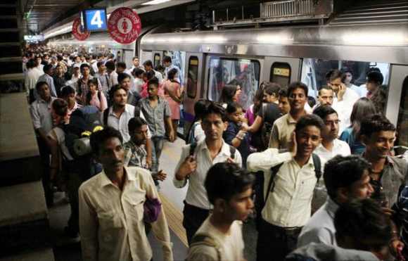 Passengers alight the metro train in New Delhi