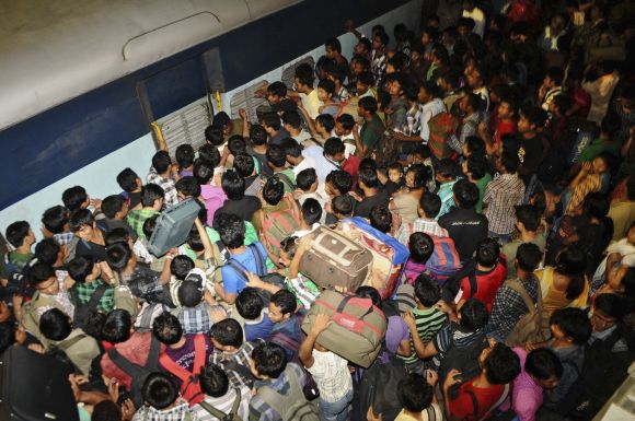 People from northeastern states crowd to board a train back to their homes at the Bangalore railway station