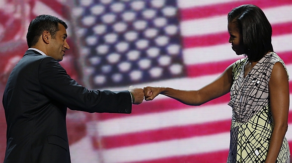 US first lady Michelle Obama 'fist-bumps' actor and Obama administration official Kal Penn, the associate director of the White House Office of Public Engagement, as she tours the stage a day before her speech to the Democratic National Convention in Charlotte, North Carolina