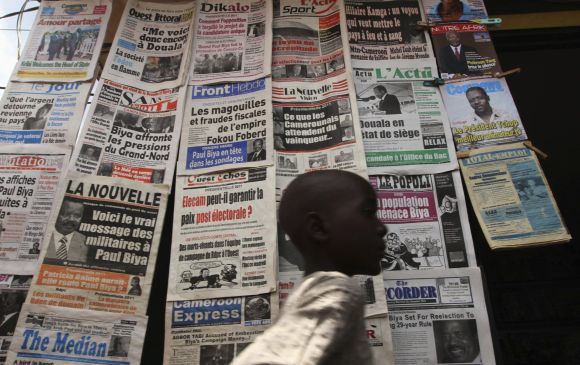 A boy walks past a newspaper kiosk at the Carrefour Wada district in Cameroonian capital Yaounde
