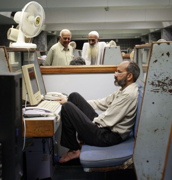 A man works on his computer in Karachi