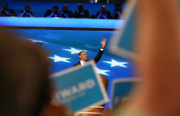 Delegates wave signs and cheer as US President Barack Obama accepts the 2012 Democratic presidential nomination