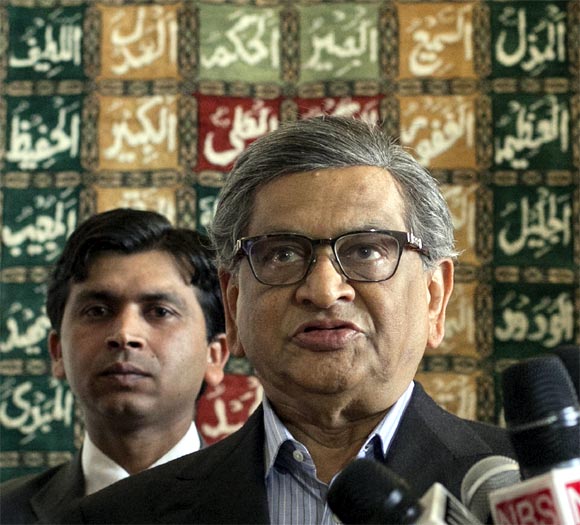 Krishna speaks to the media after his arrival at a military base in Rawalpindi near Islamabad