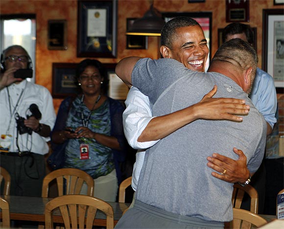 Obama hugs Scott Van Duzer at Big Apple Pizza and Pasta Italian Restaurant in Fort Pierce, Florida
