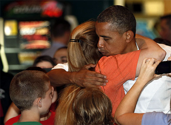 Obama hugs a supporter at the Gator's Dockside restaurant while campaigning in Orlando, Florida