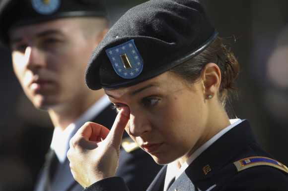 US Army Second Lieutenant Michelle Mudge wipes a tear during ceremonies marking the 11th anniversary of the 9/11 attacks