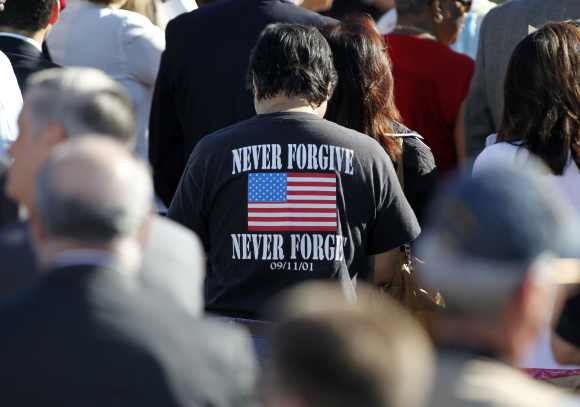 A man wears a t-shirt which honours those who died during the attacks of September 11, 2001 during a memorial service