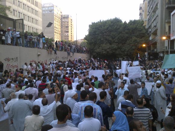 People attend a rally in front of the US embassy in Cairo